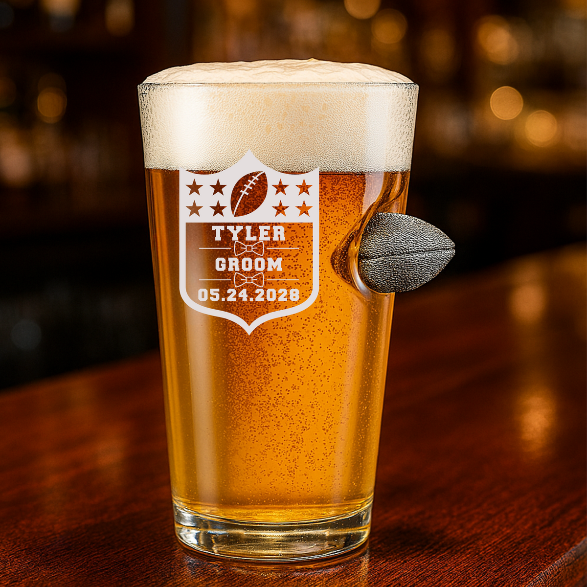 Personalized groomsmen football pint glass with engraved name, wedding role, and date