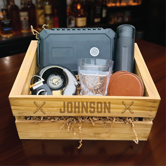 Ultimate personalized cigar gift set with engraved wooden crate, whiskey glass with cigar holder, and humidor for groomsmen.