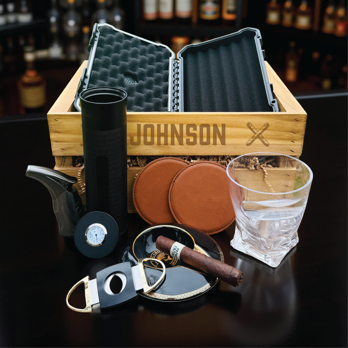 Ultimate personalized cigar gift set with engraved wooden crate, whiskey glass with cigar holder, and humidor for groomsmen.