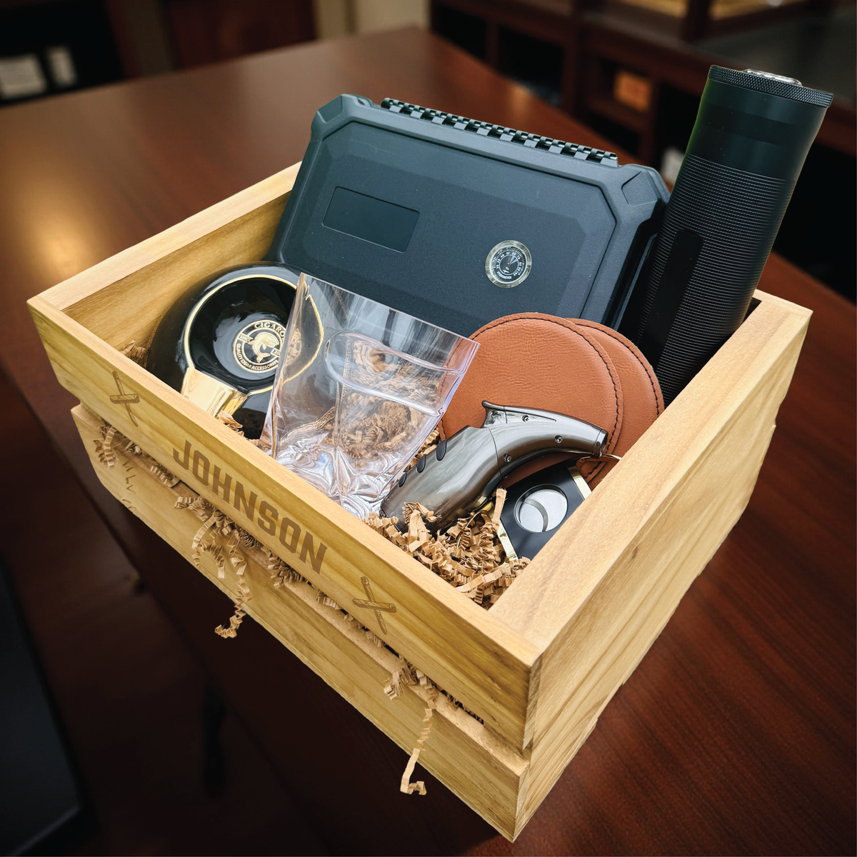 Ultimate personalized cigar gift set with engraved wooden crate, whiskey glass with cigar holder, and humidor for groomsmen.